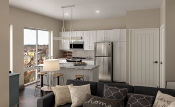 A modern kitchen with a large island and a refrigerator.